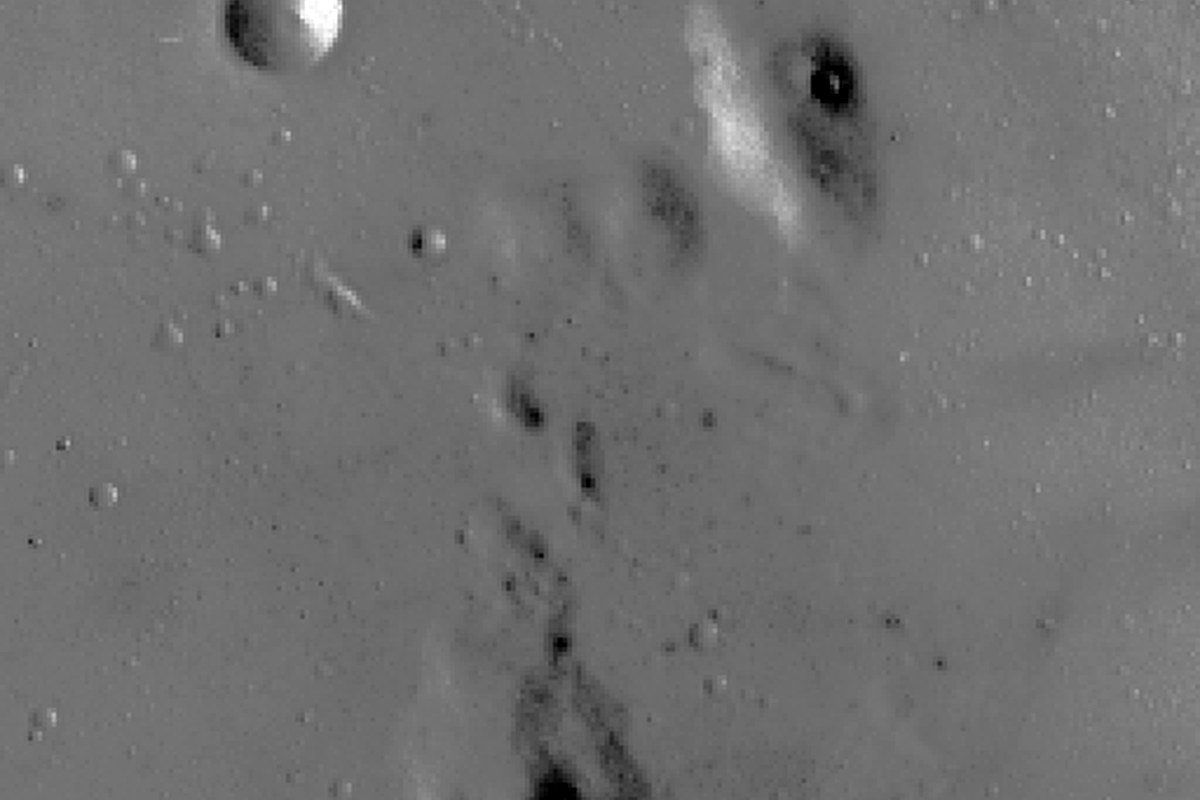 A detailed monochrome view of the moon's cratered surface.